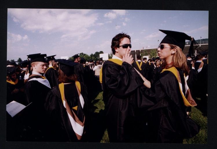 Graduate male smoking, female graduate next to him | Lehigh Preserve